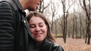 Joyful couple enjoying autumn park together