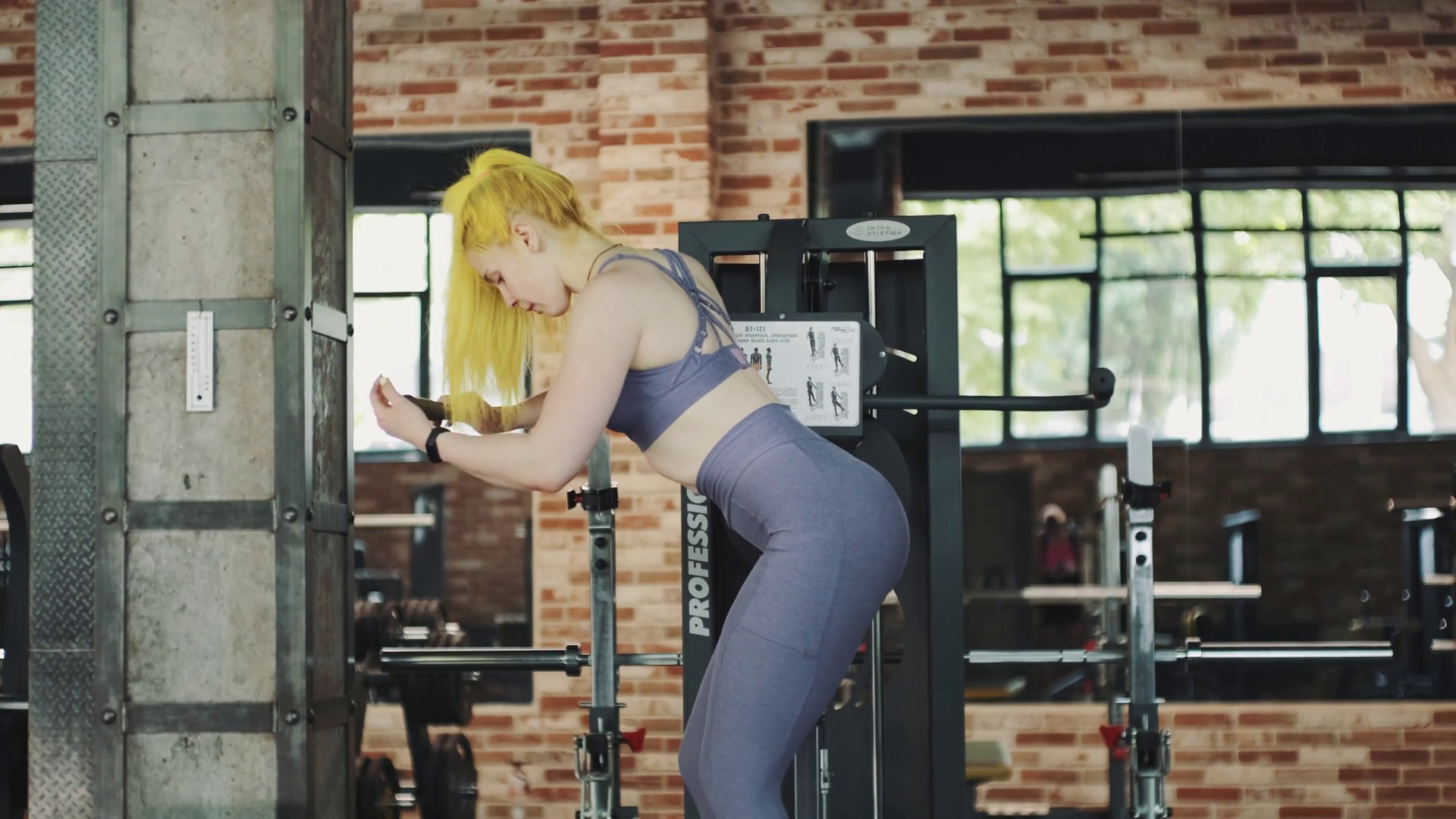 Gorgeous female professional bodybuilder doing workout exercises in gym ...