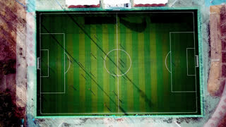 Teamwork and competition concept aerial view of soccer players training on a green