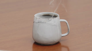 Served Smoking hot black specialty coffee on wooden table