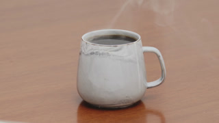 Served Smoking hot black specialty coffee on wooden table