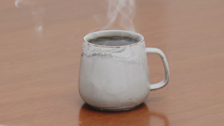 Served Smoking hot black specialty coffee on wooden table