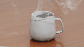 Served Smoking hot black specialty coffee on wooden table