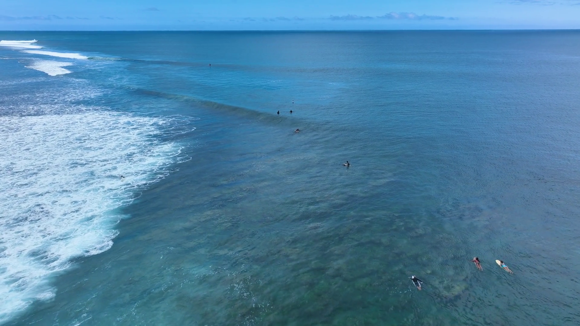 Surfers Riding Waves In Open Ocean Near Reef Stock Footage SBV ...