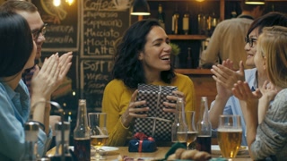 In the Bar/ Restaurant Beautiful Hispanic Woman Receives Gifts and Congratulations From Her Best Friends. Everybody is Happy!