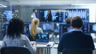Multi-Ethnic Team of Research Engineers, Neural Network Architects, Programmists Working on a Machine Learning, Neural Network Building Project. Office Displays Show Working Model of Neural Network.