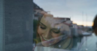 Close up of cheerful young couple is enjoying time together in a hotel room with panoramic view du