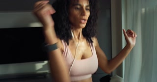 Portrait of Strong Southeast Asian Fitness Girl in Workout Clothes Doing Exercises and Monitoring her Calories at Home. Female Fitness Enthusiast Training, Working on her Stamina. Slow Motion