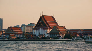 Magnificent buddhist Kalayanamit temple stands on Chao Phraya river bank. Beautiful traditional architecture in modern metropolis of Bangkok