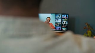 Focus on screen of TV set with young female suspect looking through photos from crime scene and communicating with investigators, young family of three watching criminal news broadcast