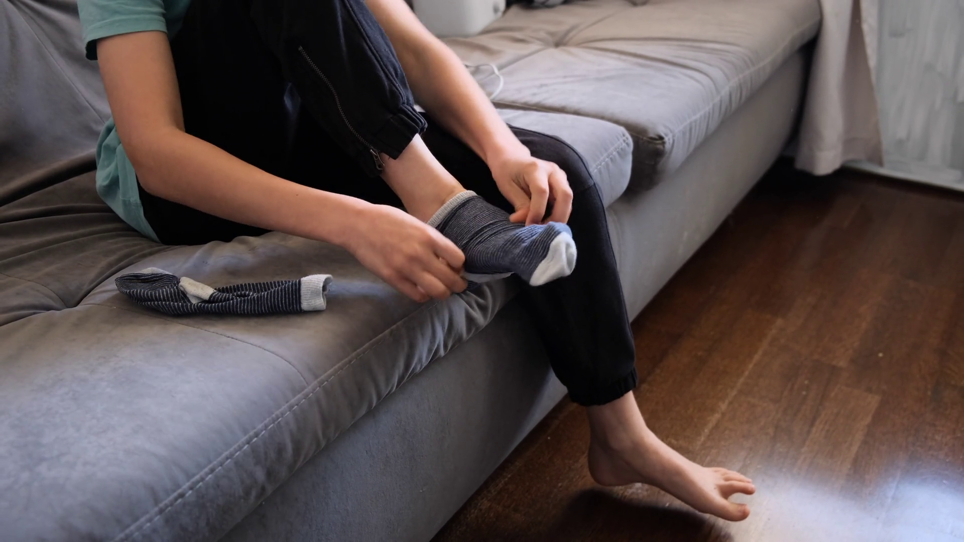 Teen Boy Putting On Socks On Sofa At Home Stock Footage SBV-352746555 ...