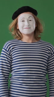 Positive Mime Waving Hello On Green Background