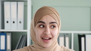 Joyful Arab Woman in Hijab Engaging in Video Call