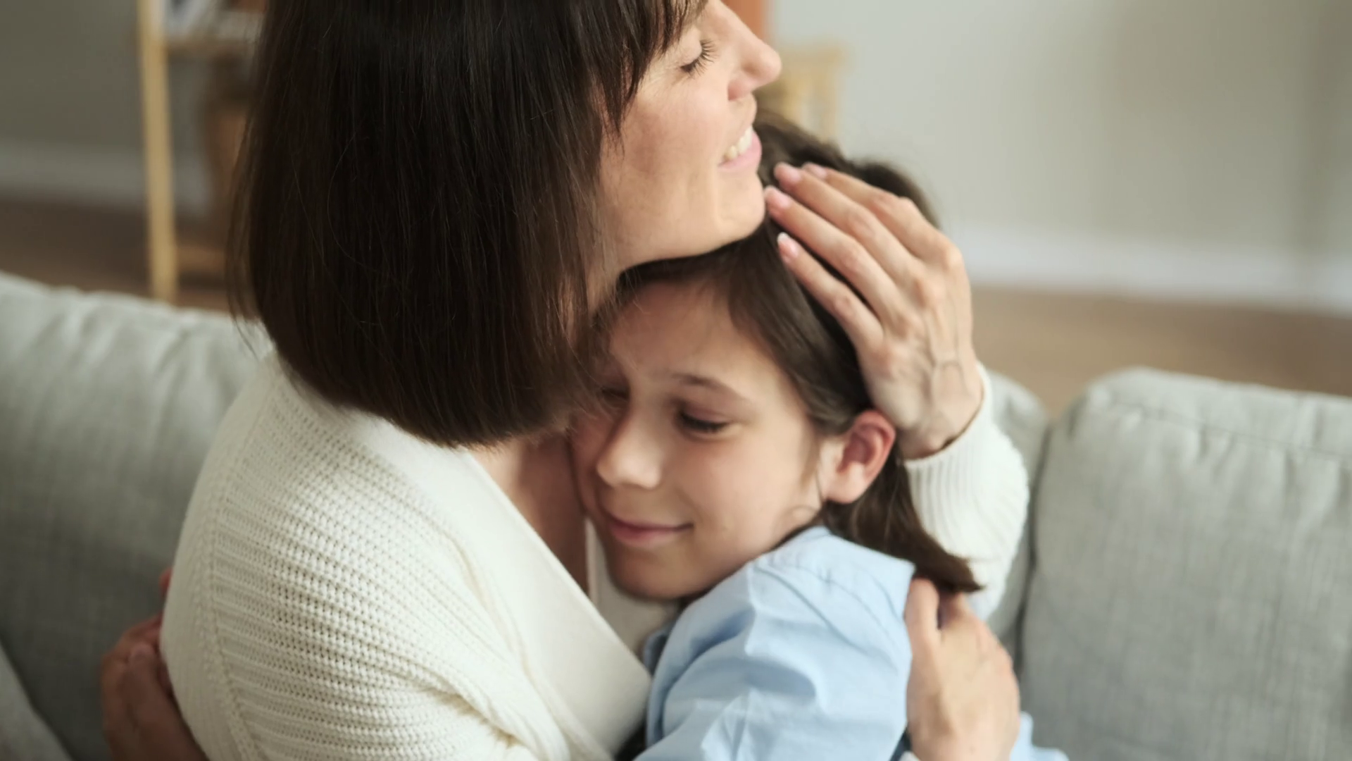 Caring Mother Hugs Son On Living Room Couch Stock Footage SBV-348559433 ...