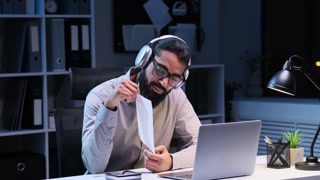 Positive Indian Businessman Participates in Evening Video Call at the Office
