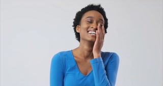 African american woman laughing over white background