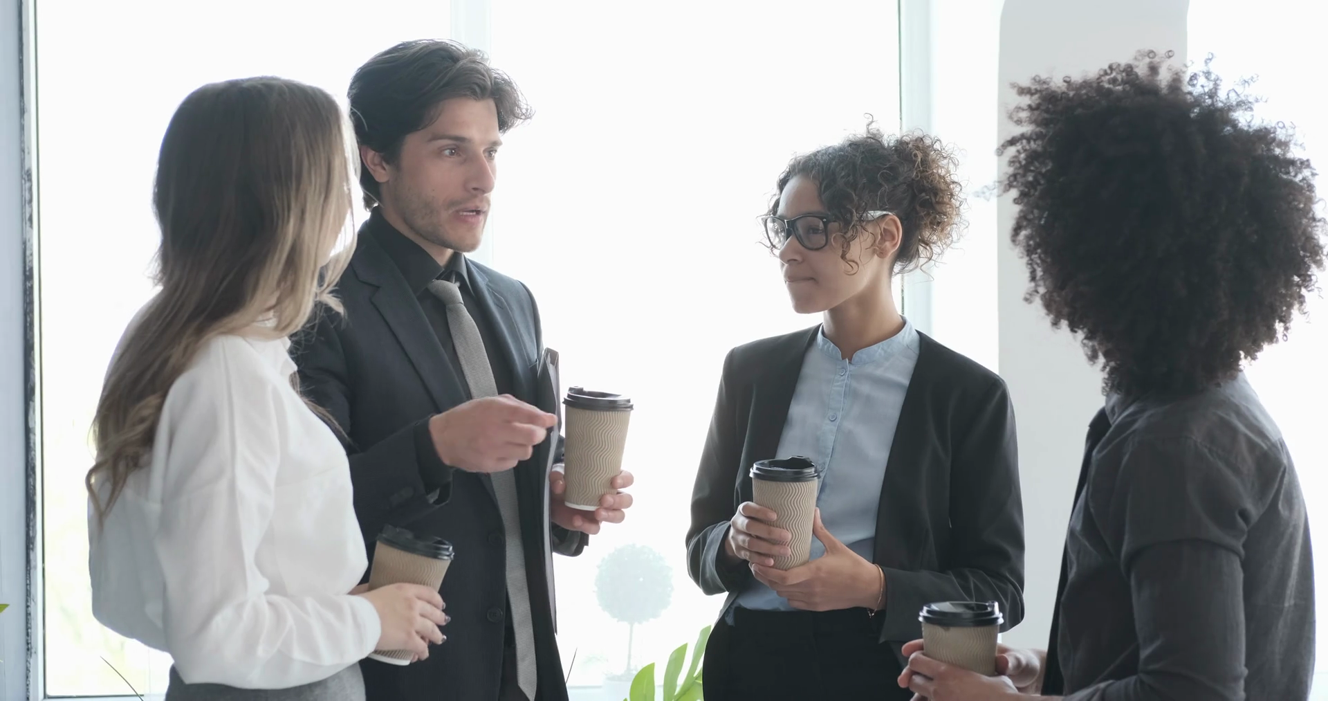 Business team discussing while having coffee in office Stock Video