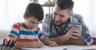 Father with son studying at home