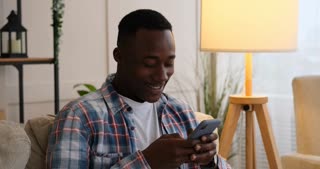 Man texting or reading funny news using mobile phone