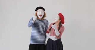 Mimic artist couple laughing over white background