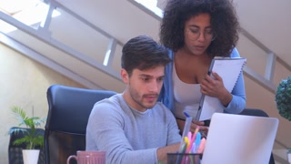 Mixed race business partners working at office