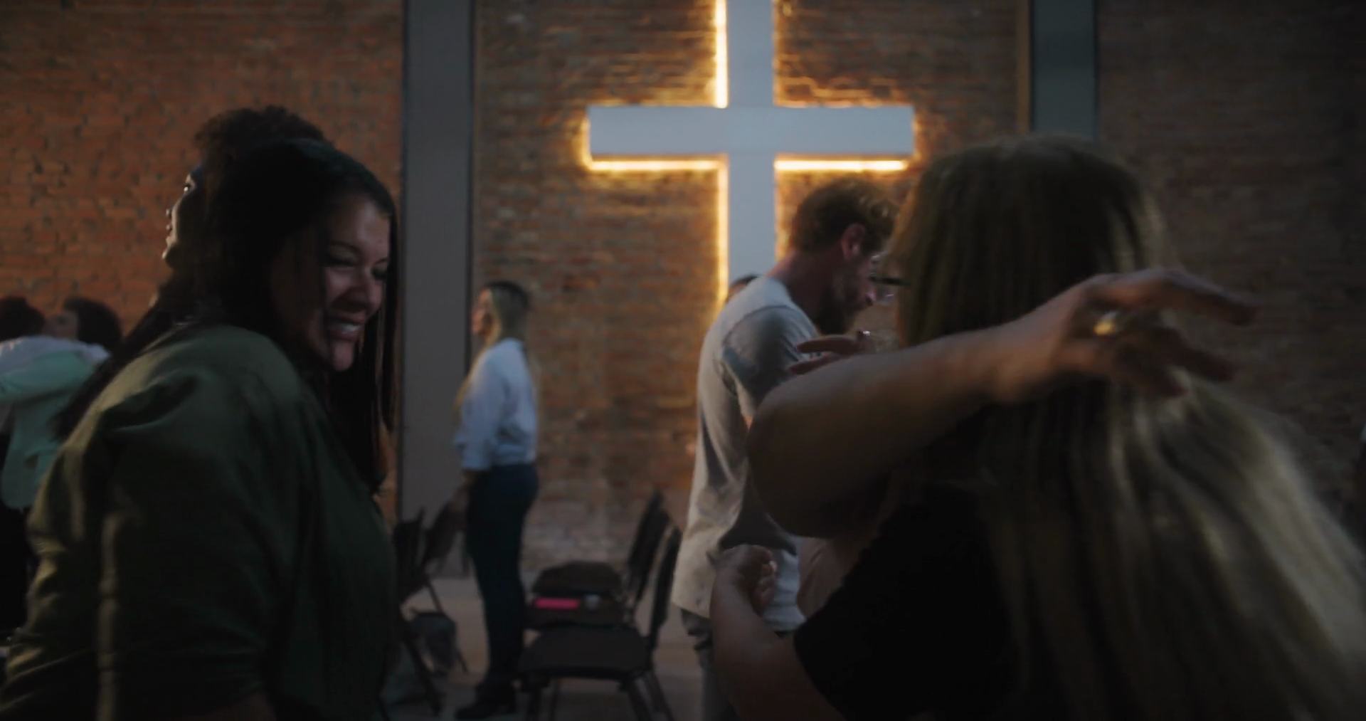 People Hugging In Church Illuminated Cross Stock Footage SBV-351819544 ...
