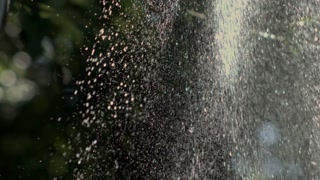 Raindrops hitting the ground in slow-motion at 1000 fps, capturing the detailed splashes and texture of water interacting with the earth, emphasizing the natural beauty of rainfall