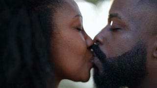 Affectionate African Couple Kissing Outside In Slow Motion At Park With Lens Flare