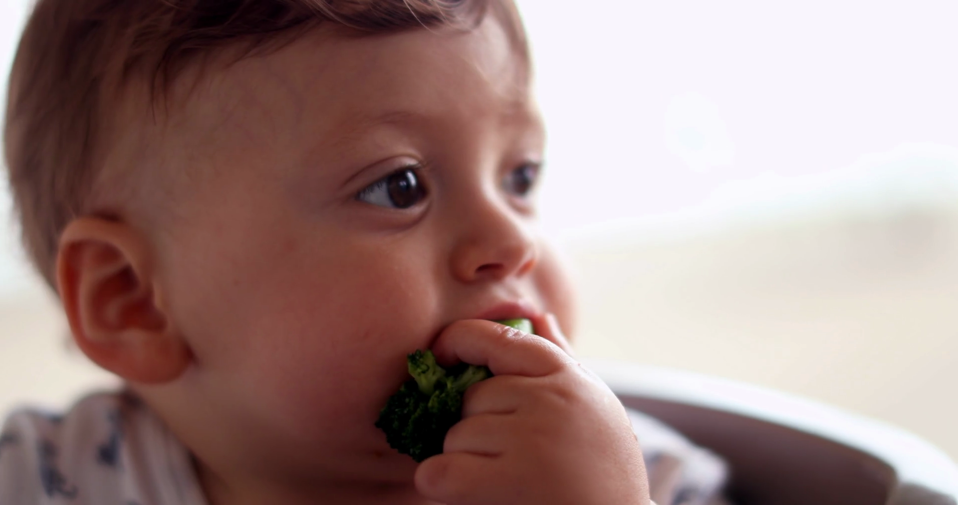 Baby Eating Broccoli Vegetable Self Feeding Stock Footage SBV348537766