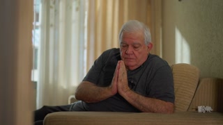 Devoted Elderly Man Praying At Home Senior Male Caucasian Engaged In Solemn Worship Signifying Faith And Spirituality