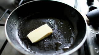 Putting butter inside pan frying