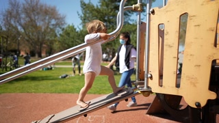 Small Child Walking On Playground Structure In Slow Motion in sunshine