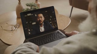 Elderly Man in a Video Conference with Business Professional