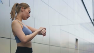 Young woman athlete stretching for exercise, pursuing healthy lifestyle, sport in city, preparing for fitness yoga