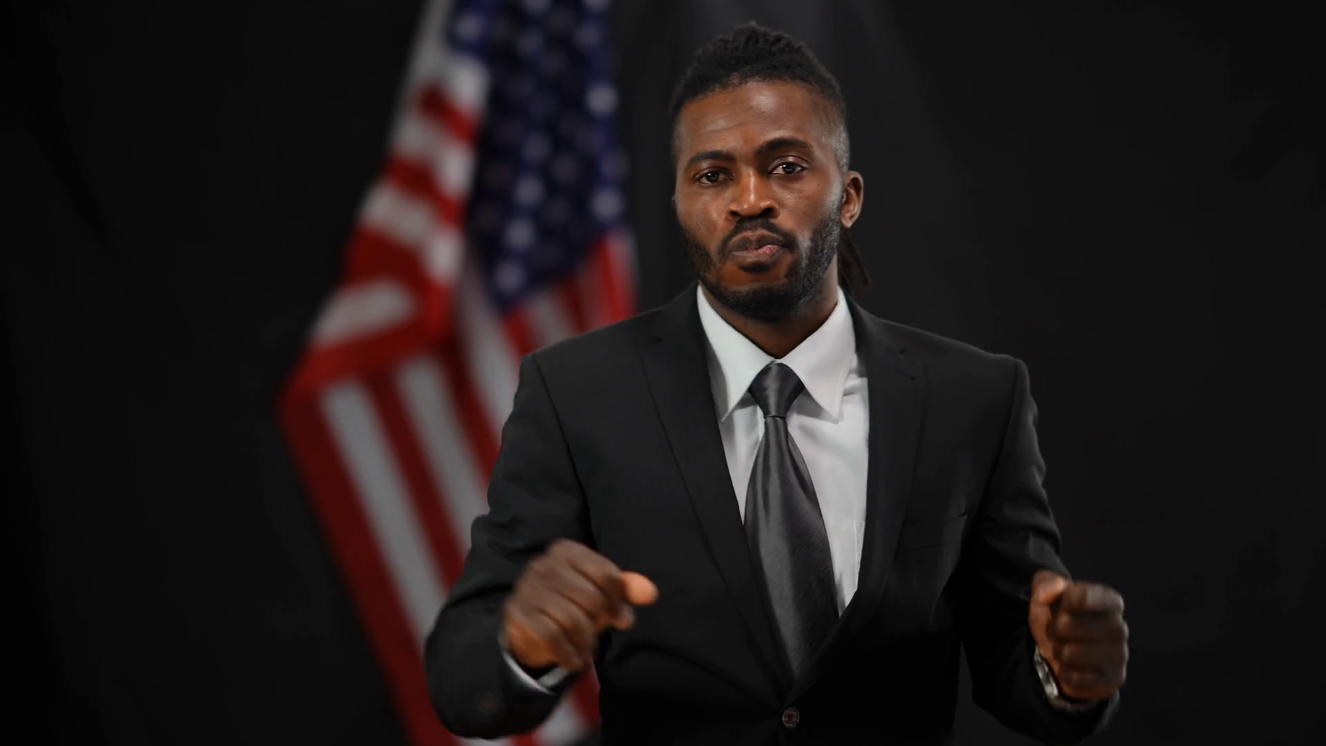 Cheerful handsome African American male politician in elegant suit