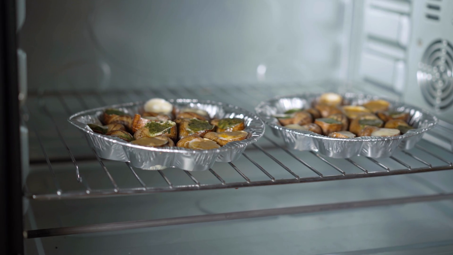 Plates With Uncooked Escargot On Oven Grid Stock Footage SBV347454707