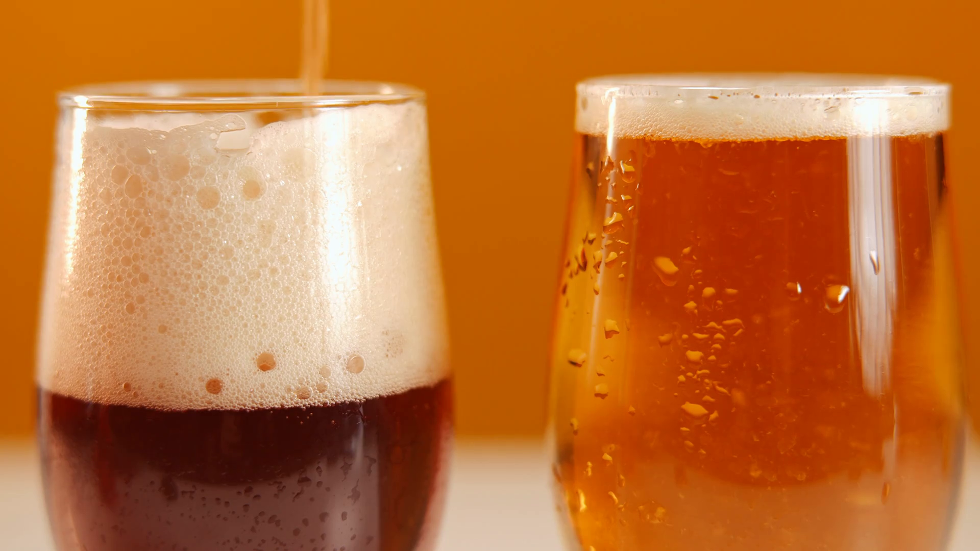 close-up-glasses-with-light-dark-beer-drink-stock-footage-sbv-347741412