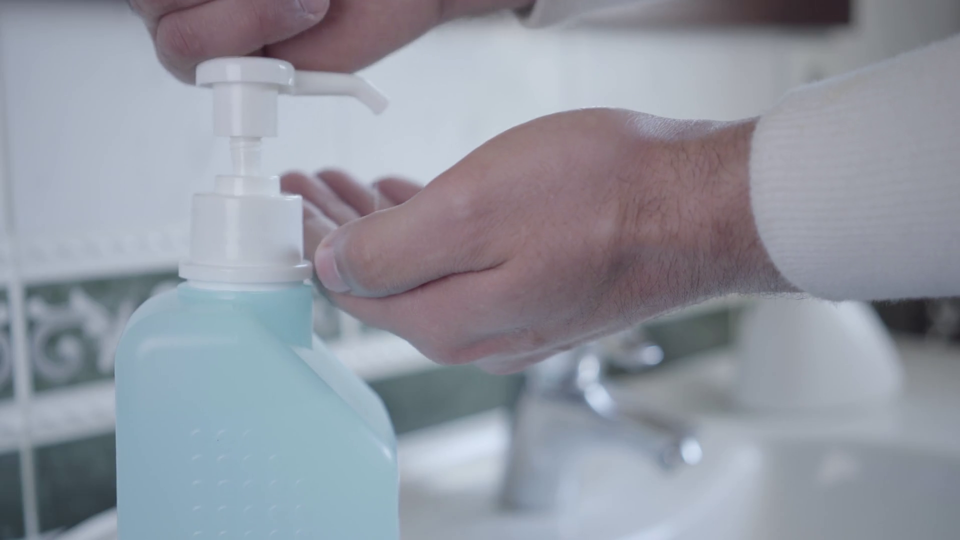 Closeup of man disinfecting hands with hand sanitizer. Male palms