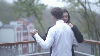 Happy couple is dancing on the balcony