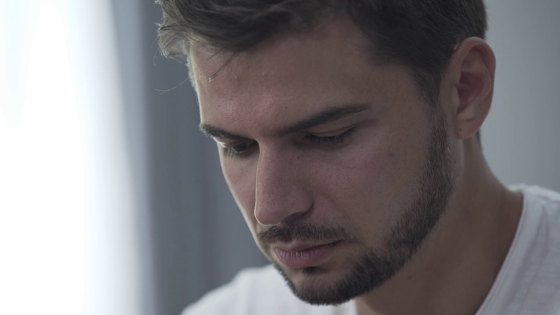 Portrait Of Young Man Rubbing Head With Stock Footage SBV337682487