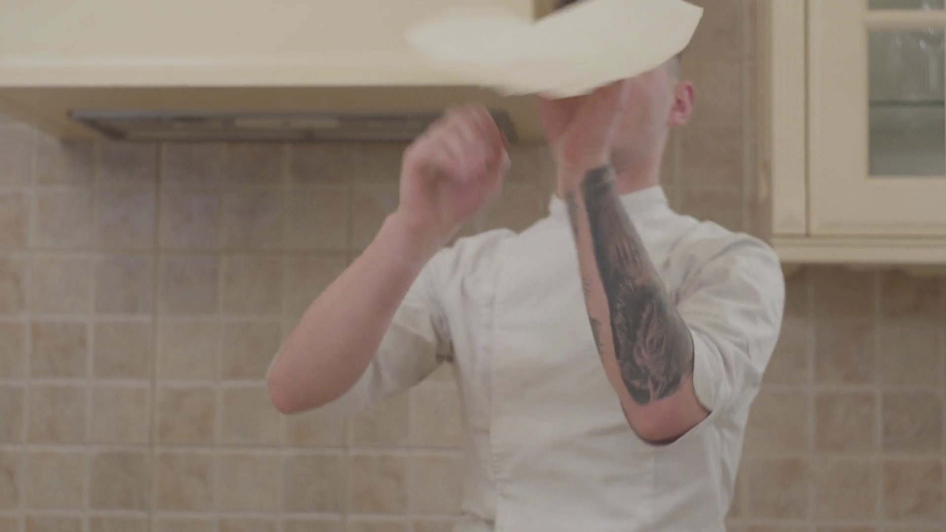 Smiling Chef Spinning Pizza Dough At Home Stock Footage SBV332837424