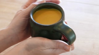 Golden Milk in a Lovely Mug on a Wooden Table