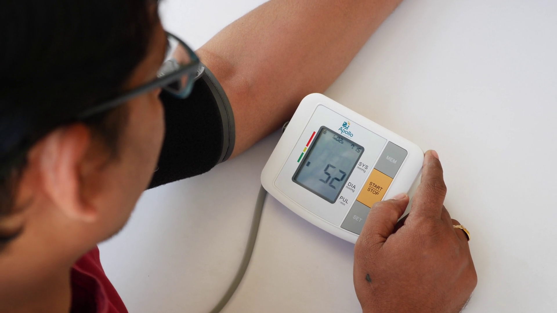 Man Turning On Digital Blood Pressure Machine Stock Footage SBV