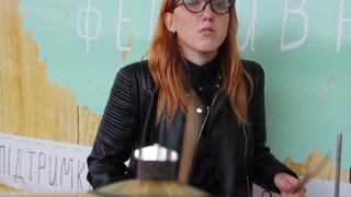 Lviv \ Ukraine - July 7 2018: Close up view of girl rock musician female drummer in slow-motion performing on a stage. Rock fest, musical band, art. Popularity, tour, fans. Female portrait
