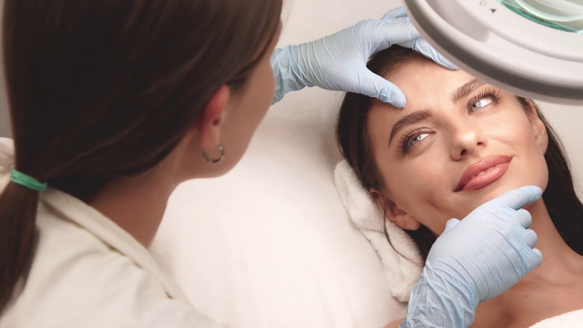 lovely female on face check at beauty clinic Stock Video Footage 0008