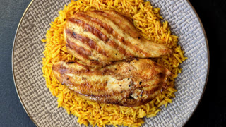 Kabsa or haneeth, an Arabic dish with rice and chicken, salt, and spices. Kabsa or haneeth
