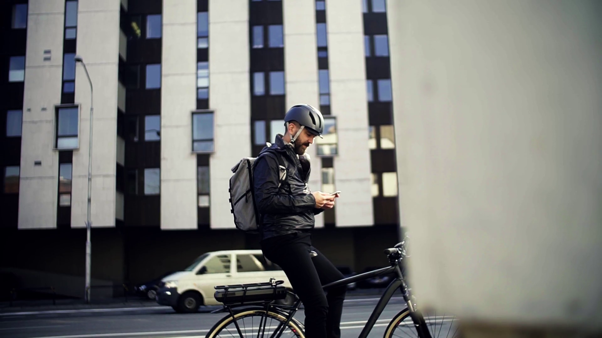 A portrait of male bicycle courier with backpack delivering packages in