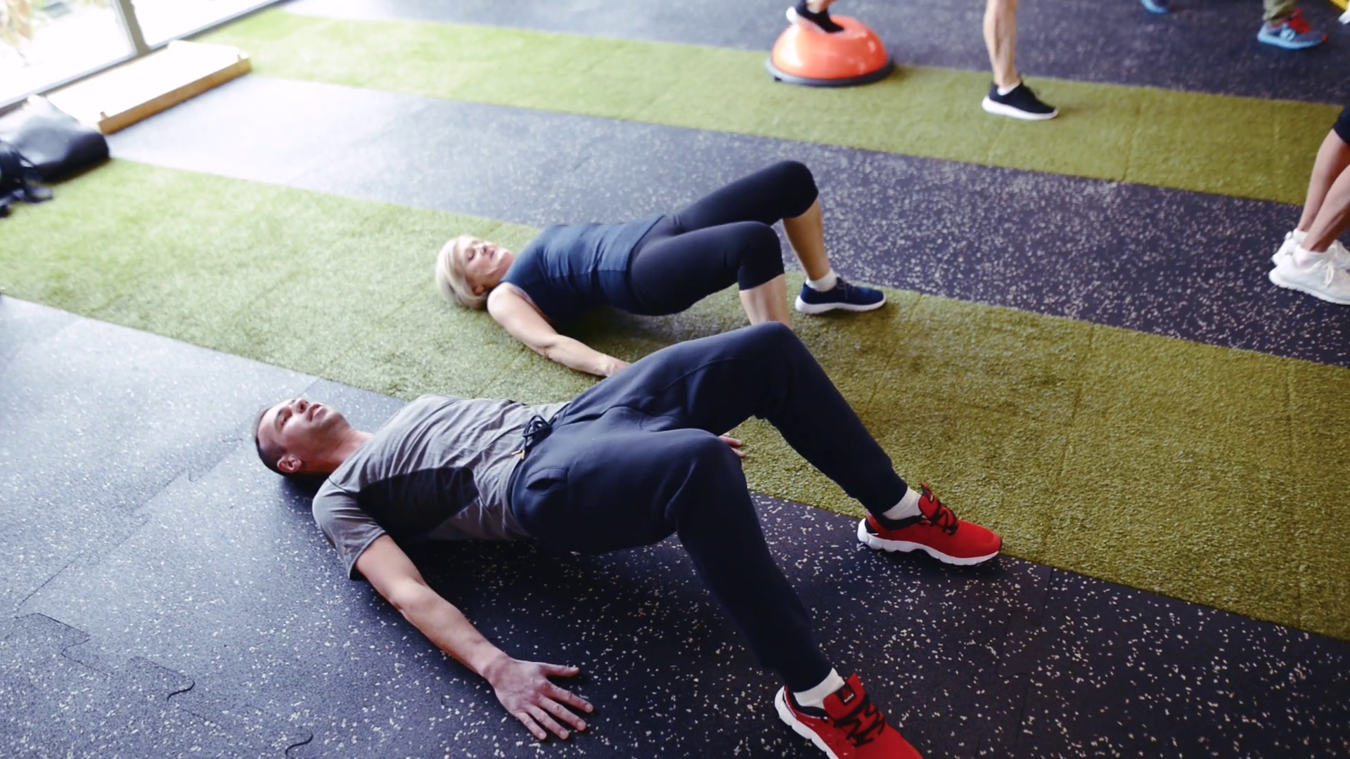 Senior Woman With Coach In Gym Doing Bridge Stock Footage SBV315319176