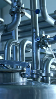 Industrial Milk Production Facility. Modern steel machines at industrial conveyor line of soft drink production plant
