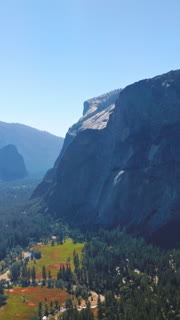 Bright sun lighting the beautiful valley among the huge mountains. Stunning scenery of Yosemite National Park, California, USA. Vertical video